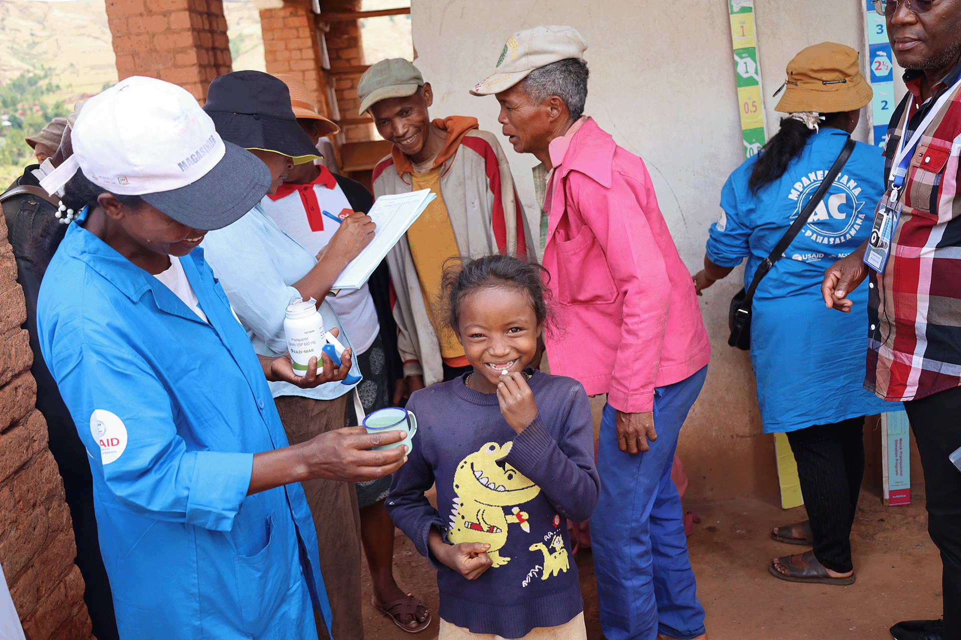 A one health approach to Integrate interventions-2 A little girl receiving a drug treatment during a one health approach to Integrate interventions to control of schistosomiasis and Taenia solium