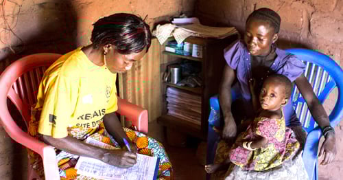 Mother and child with community health worker in the Democratic Republic of the Congo
