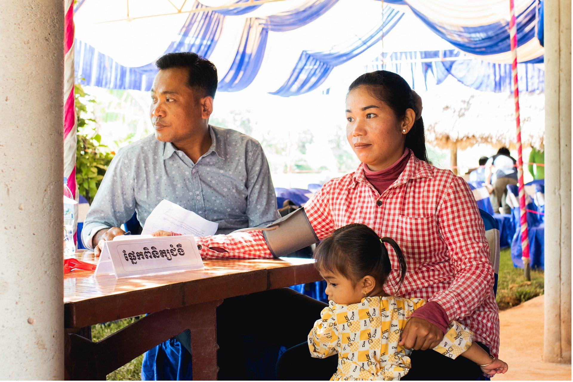 A woman has her blood pressure monitored